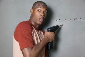 Man drilling holes in wall