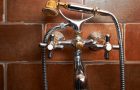 Bathroom mixing tap with shower on brown tiles