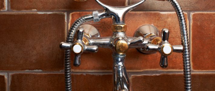 Bathroom mixing tap with shower on brown tiles